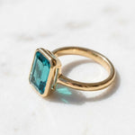 Load image into Gallery viewer, Tear Blue Topaz Ring Gold | Emerald Cut Bezel Solitaire | 18k Gold plated 925 Silver | Statement Ring | Birthday gift for her
